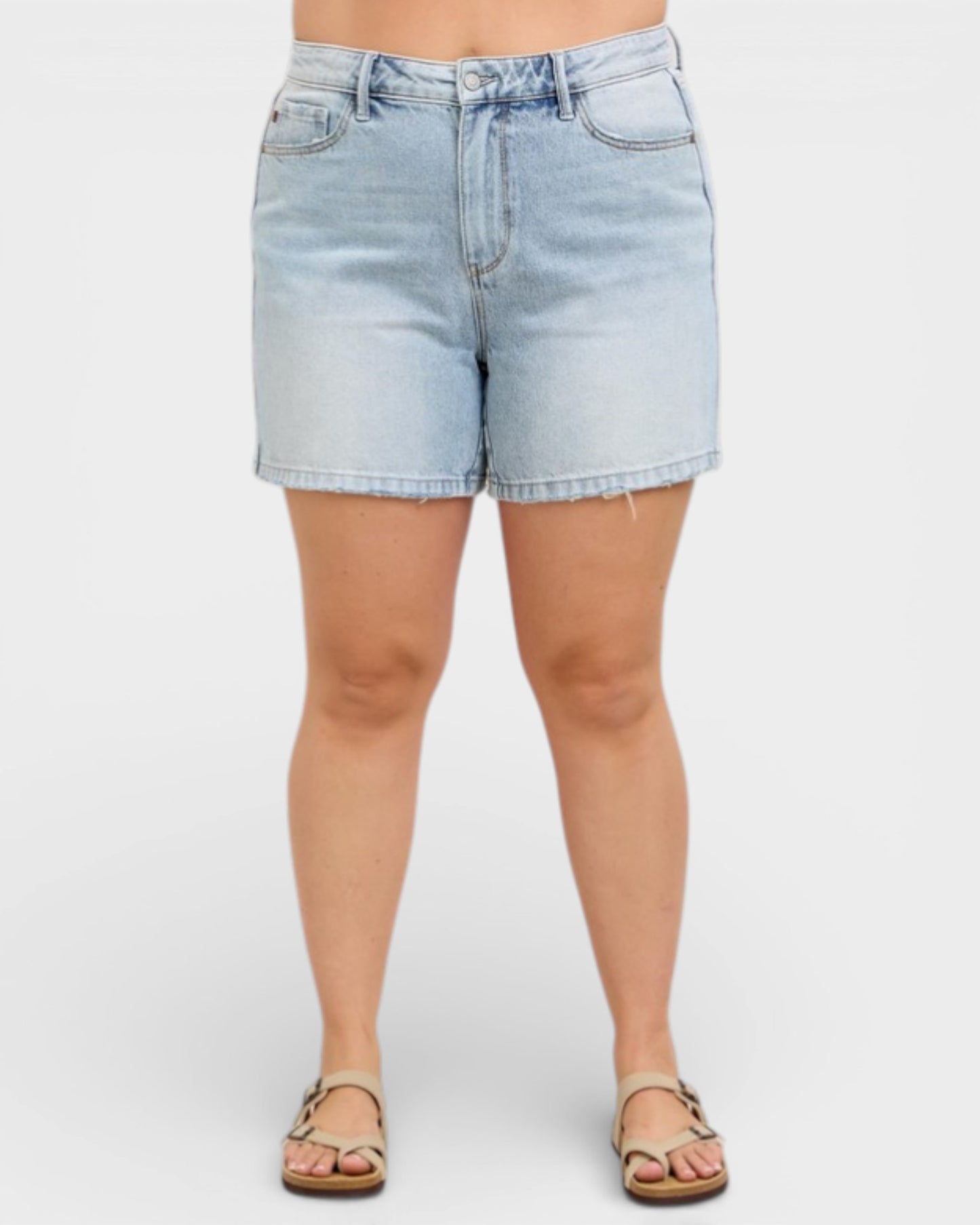 Light blue denim shorts worn by a person on a white background