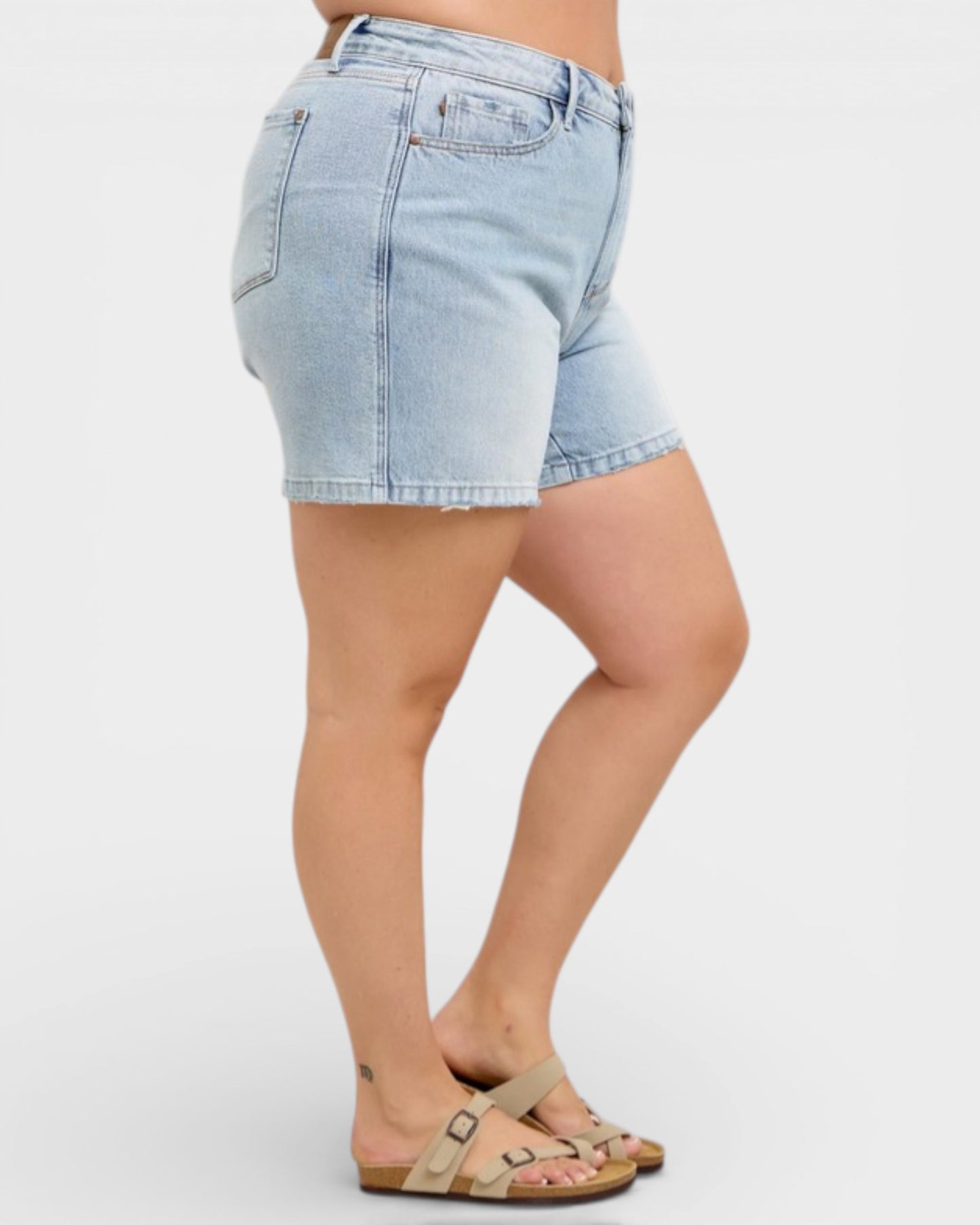 Light blue denim shorts worn by a person on a white background
