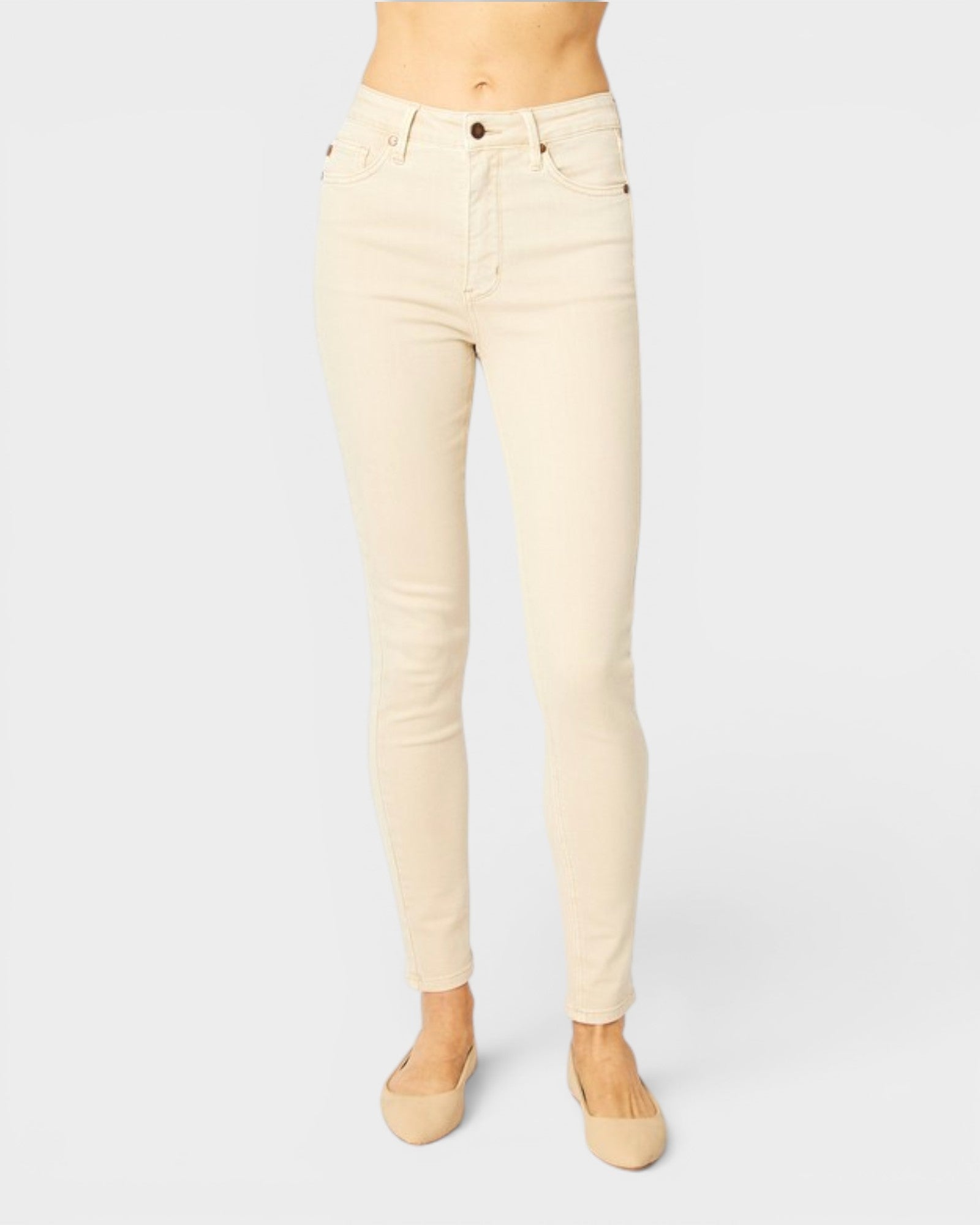 Beige jeans worn by a person on a white background