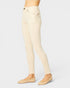 Beige jeans worn by a person on a light gray background