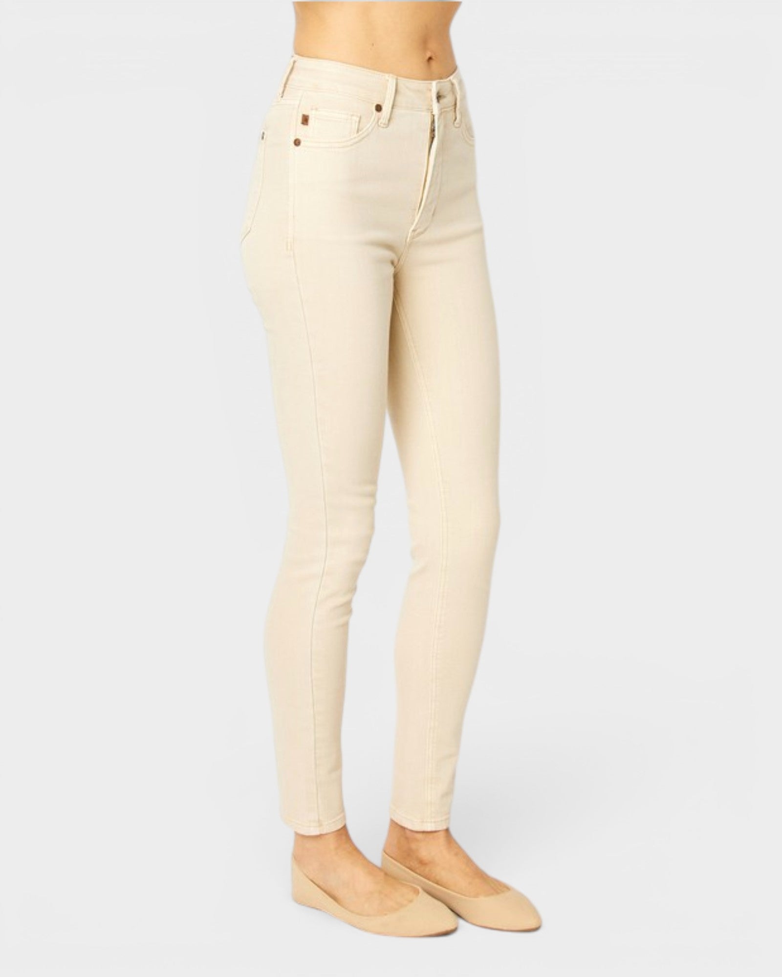 Beige jeans worn by a person on a white background