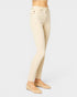 Beige jeans worn by a person on a light gray background