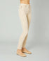 Beige jeans worn by a person on a gray background
