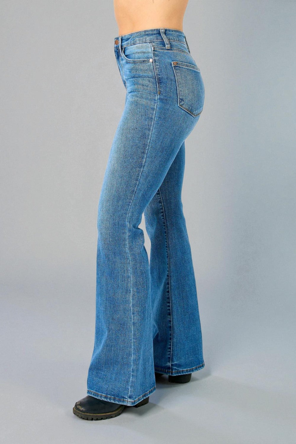 Blue bell-bottom jeans on a plain background