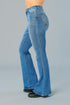 Blue jeans worn by a person on a gray background
