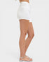 White denim shorts worn by a person on a white background