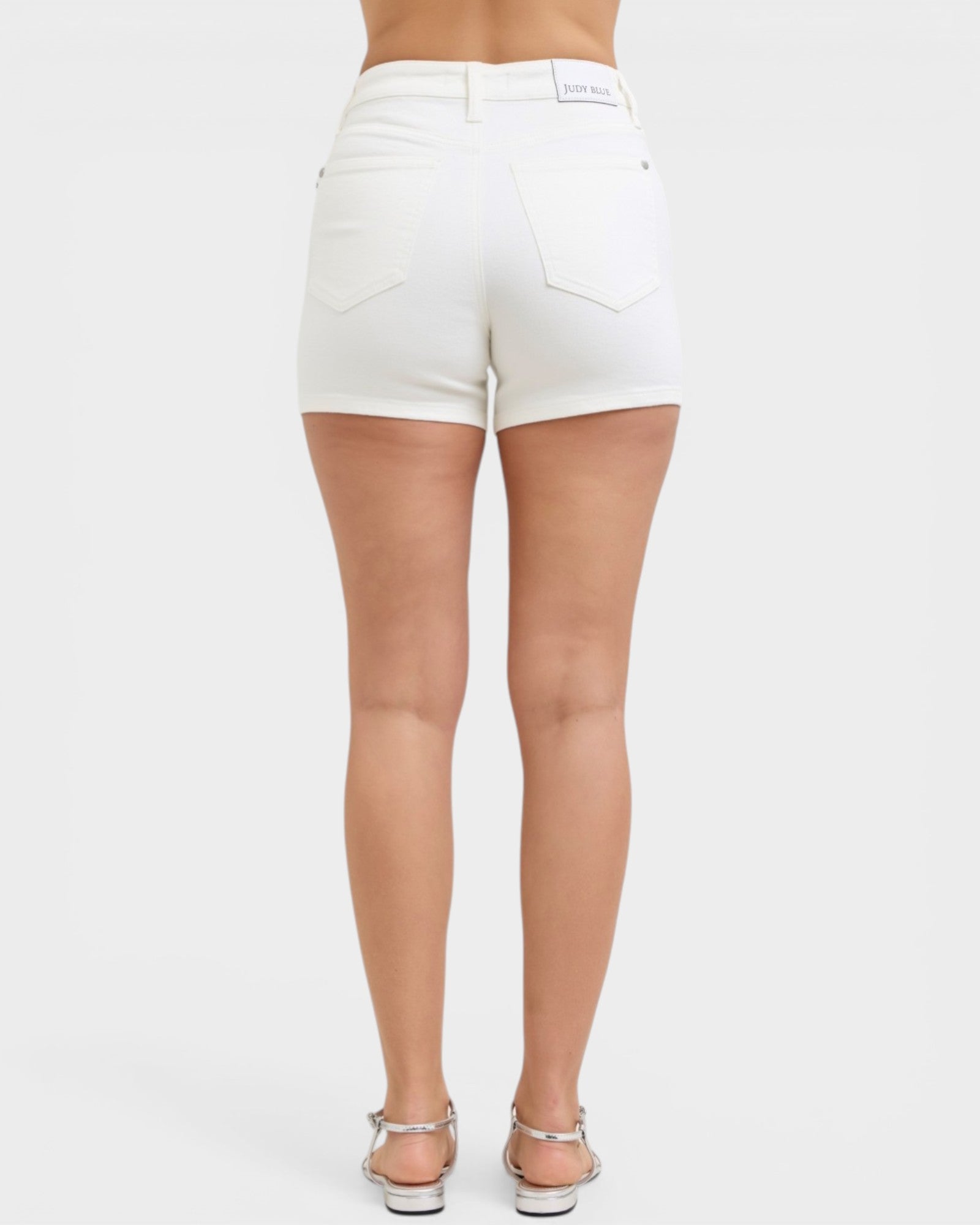 White shorts worn by a person on a white background