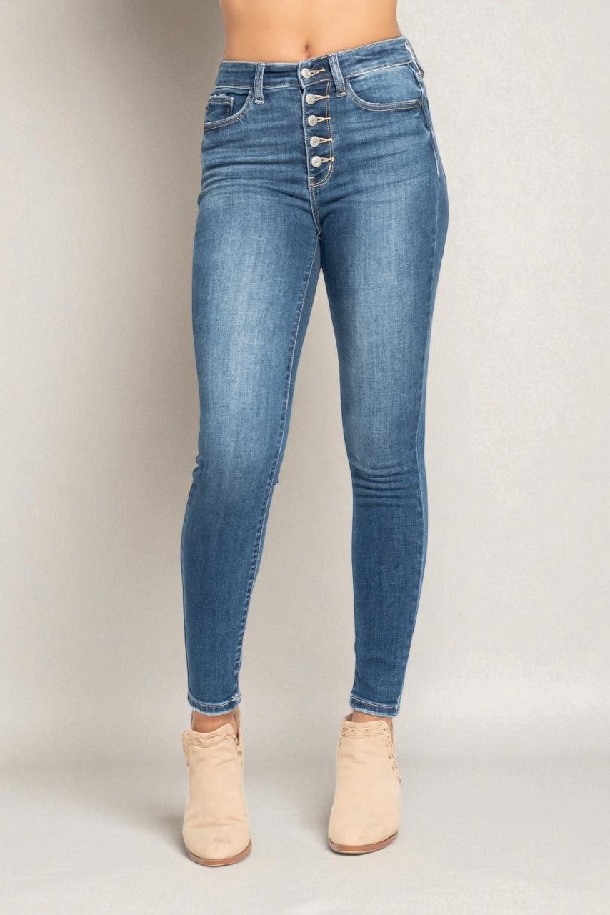 Blue jeans worn by a person on a plain background