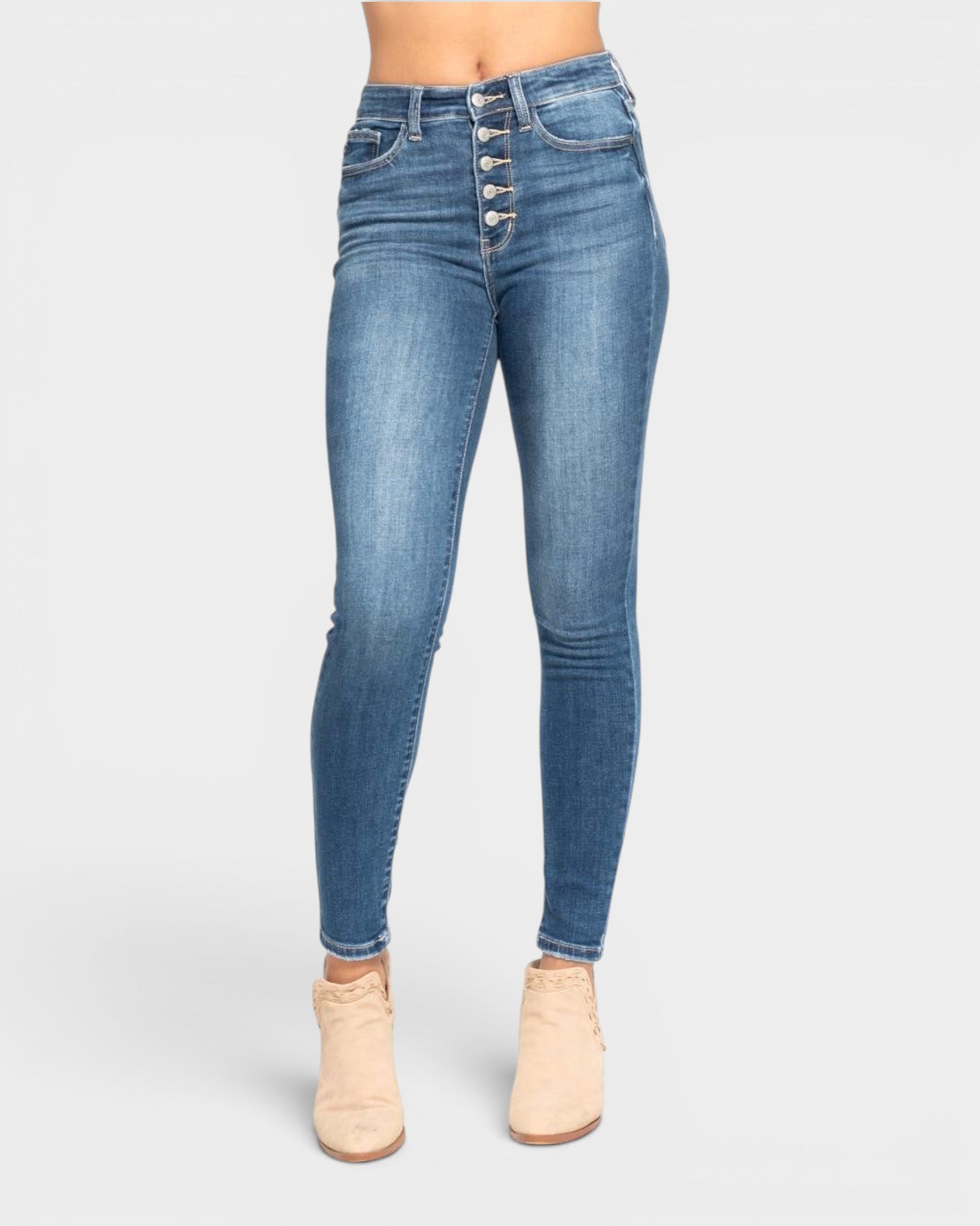 Blue jeans with button details on a white background