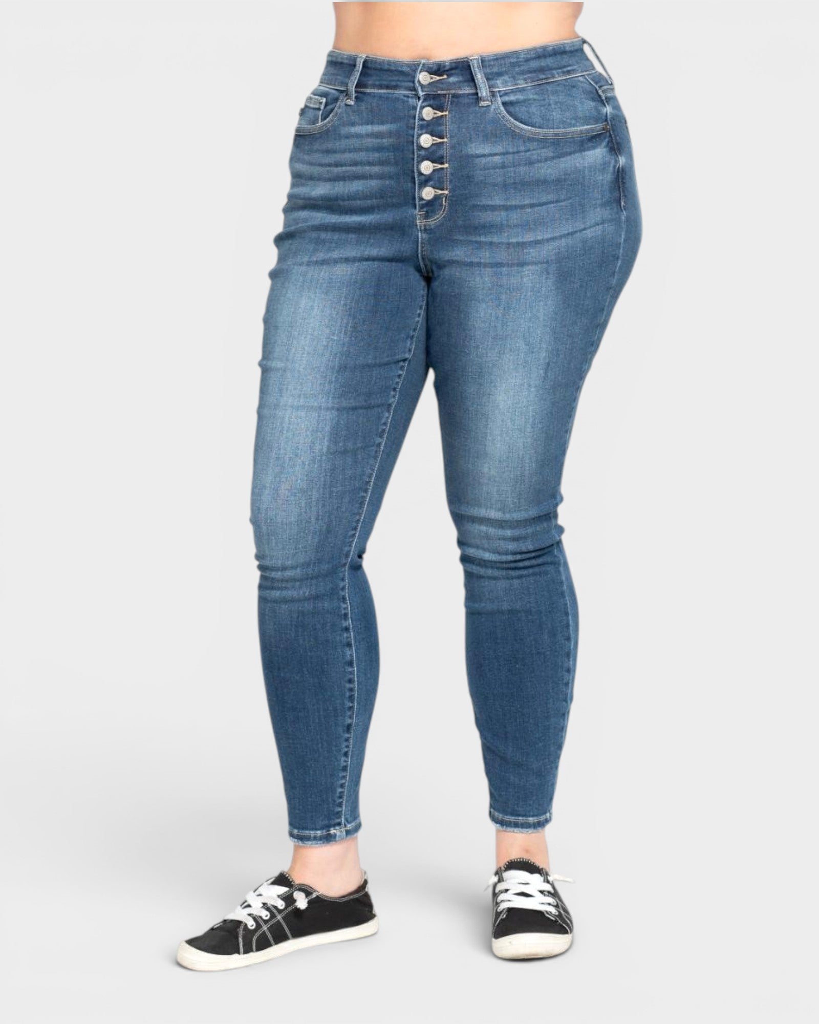 Blue jeans with button fly on a white background