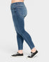 Blue jeans worn by a person on a white background