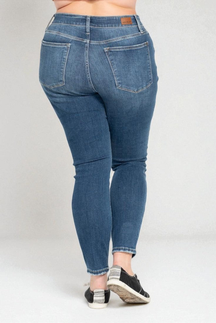 Blue jeans worn by a person on a white background