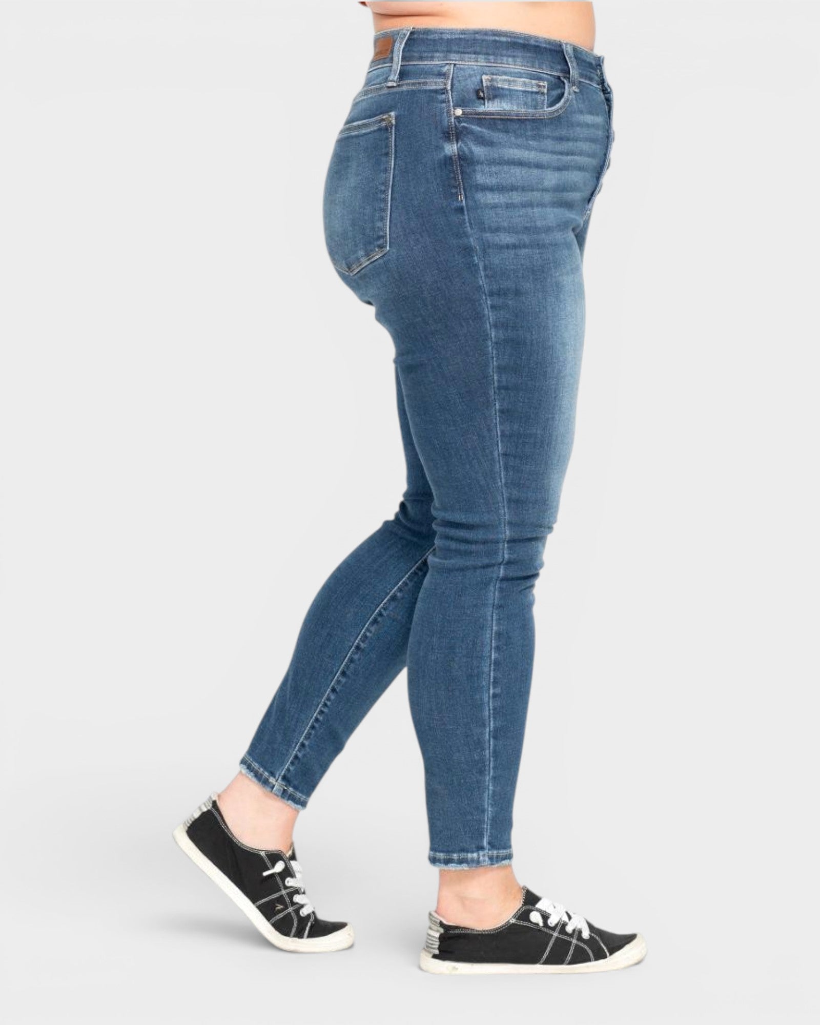 Person wearing blue jeans on a white background