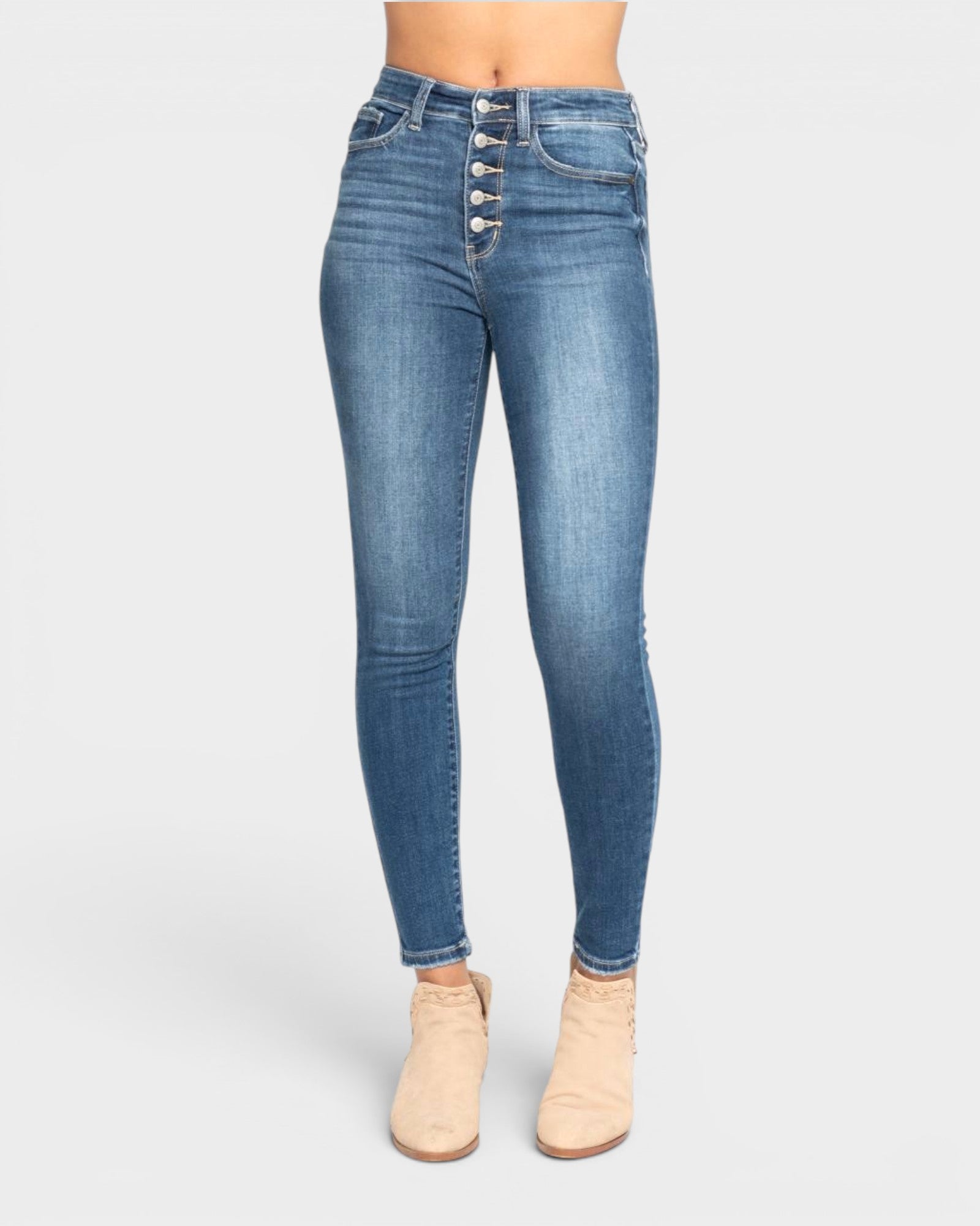 Blue jeans with button details on a white background