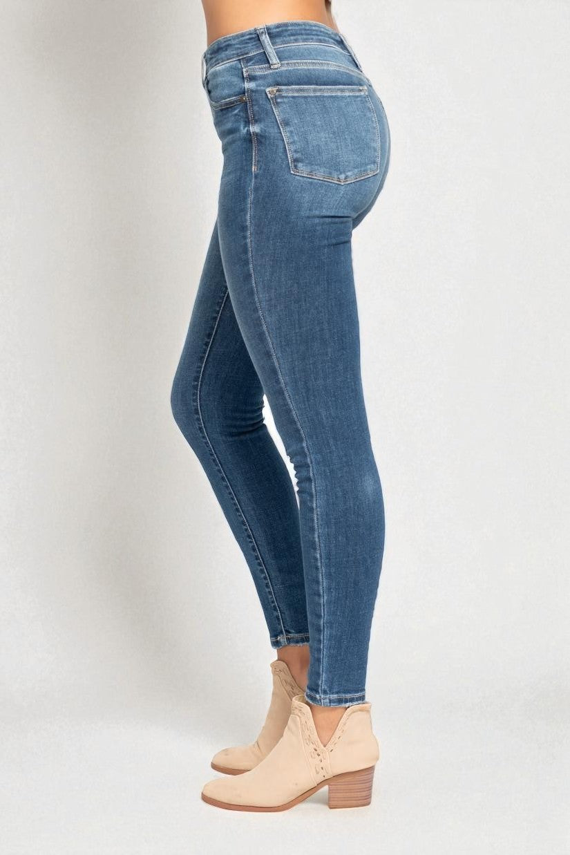 Blue jeans worn by a person on a white background