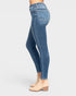 Blue jeans worn by a person on a white background