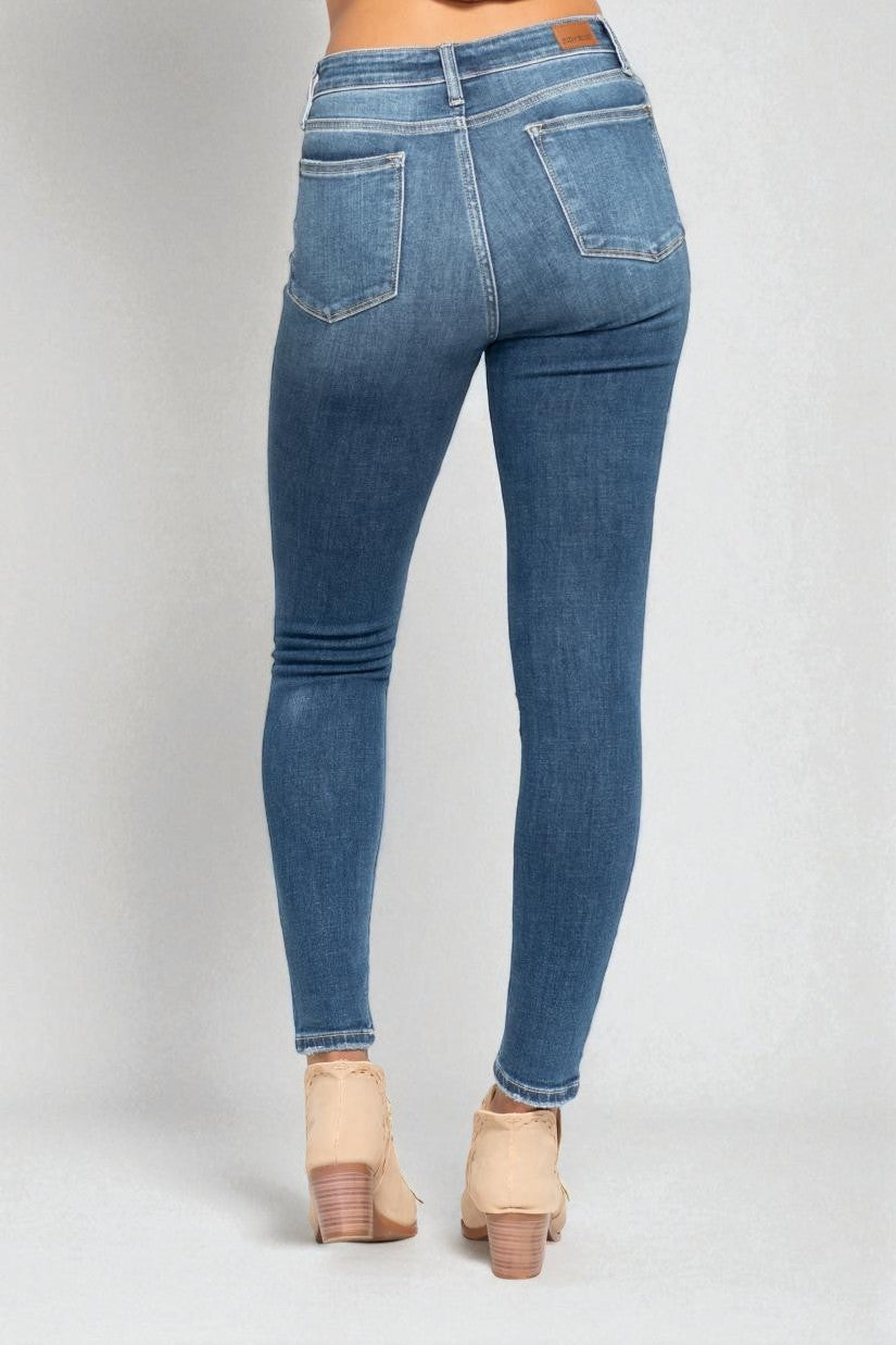 Blue jeans worn by a person on a white background