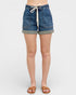 Denim shorts worn by a person on a white background