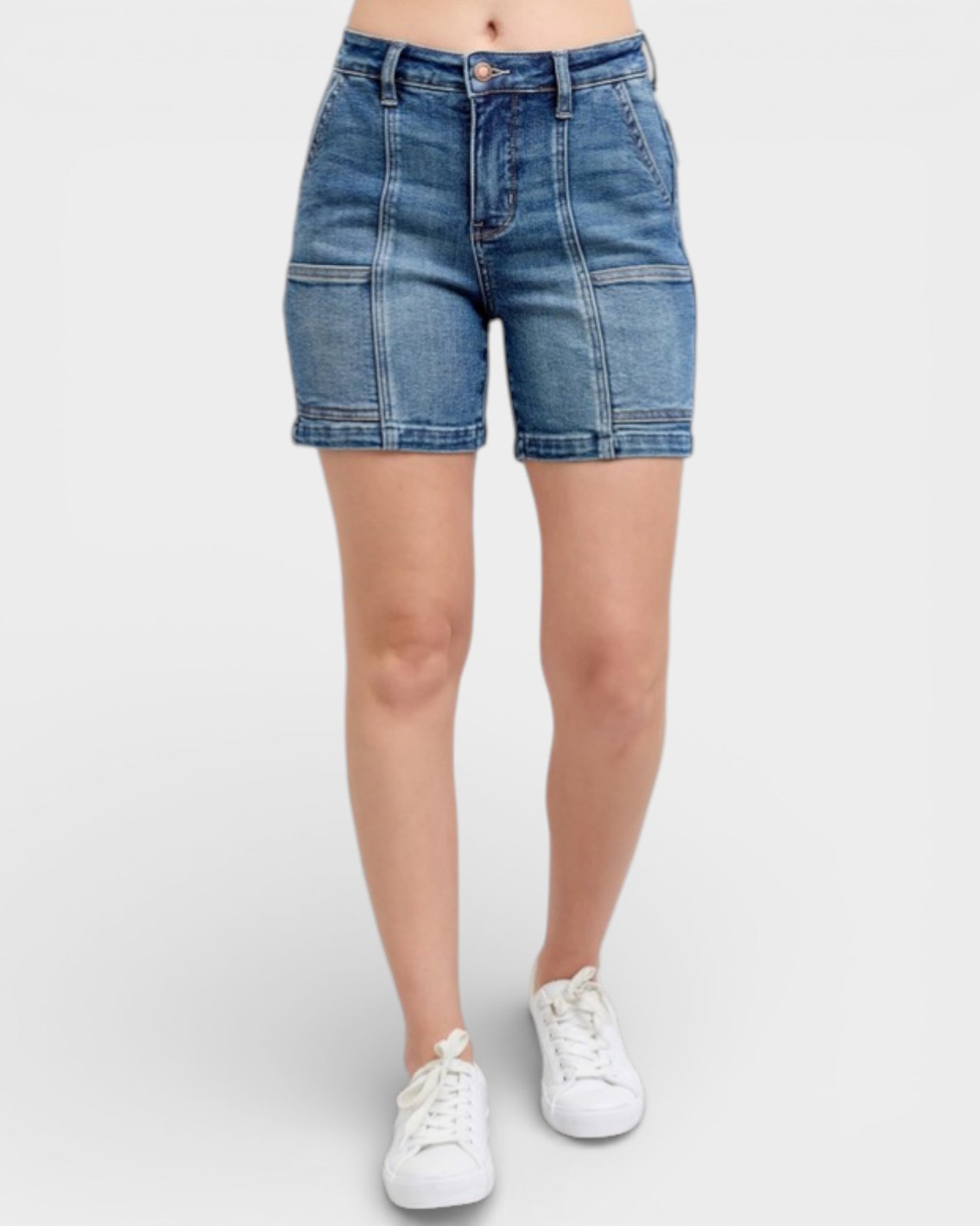 Denim shorts worn by a person on a white background