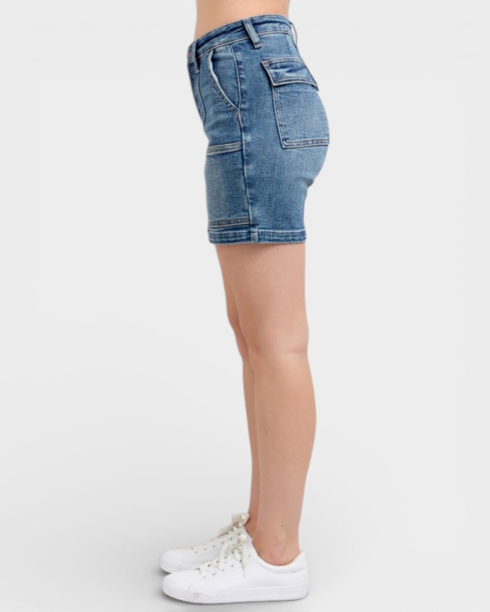 Denim shorts worn by a person on a white background