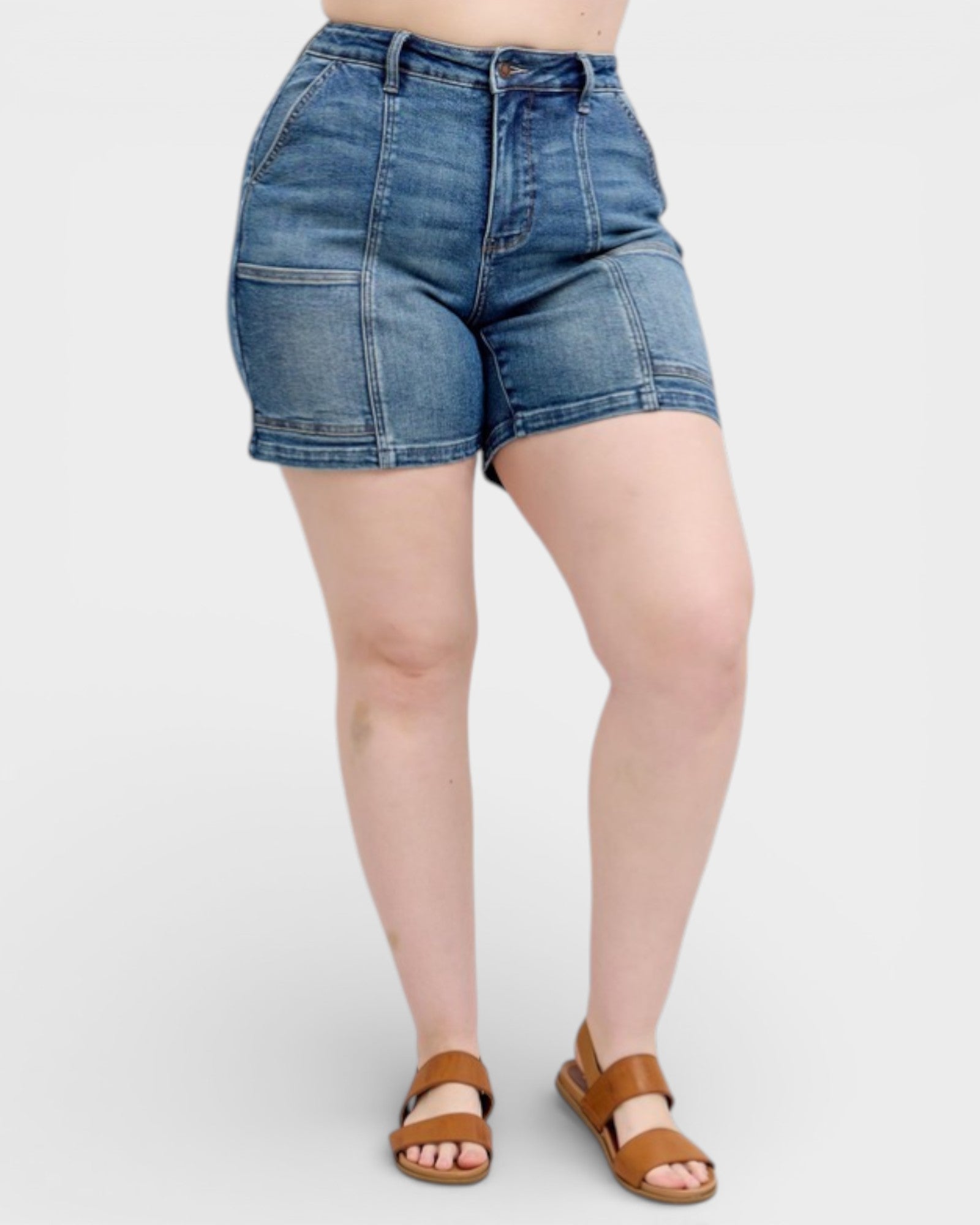 Person wearing blue denim shorts on a white background