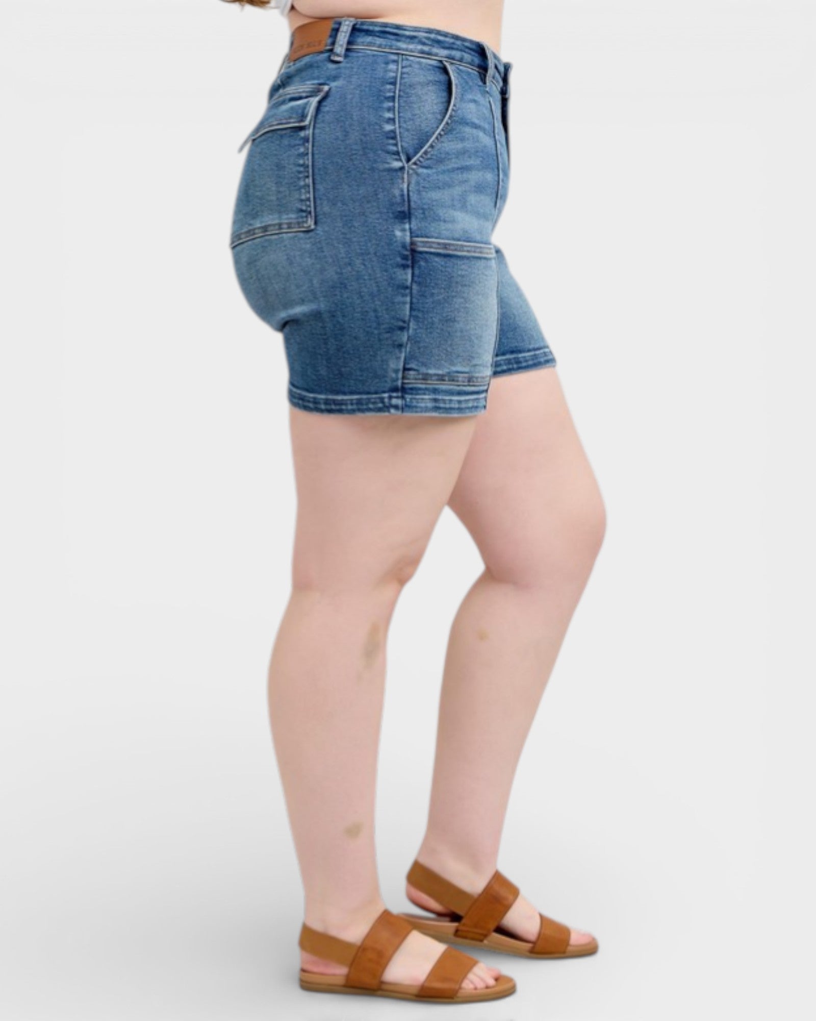 Denim shorts worn by a person on a white background
