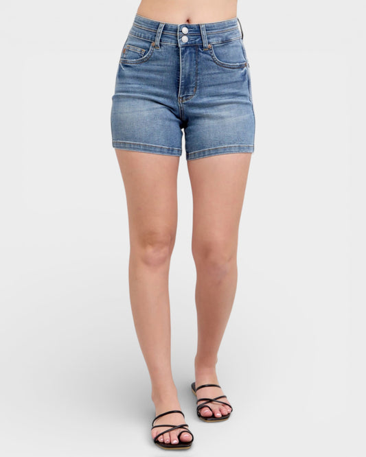 Denim shorts worn by a person on a white background