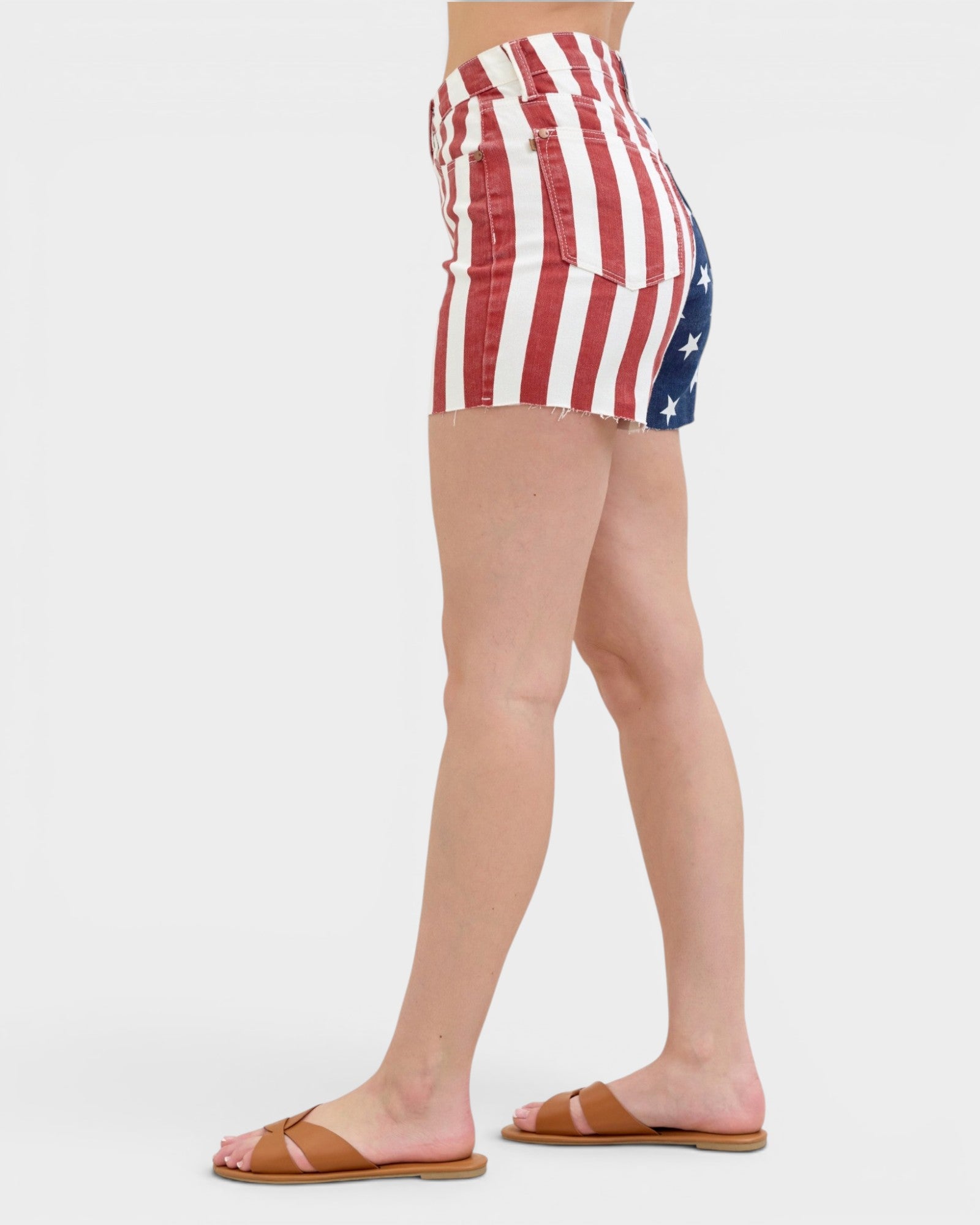 Person wearing American flag patterned shorts on a white background