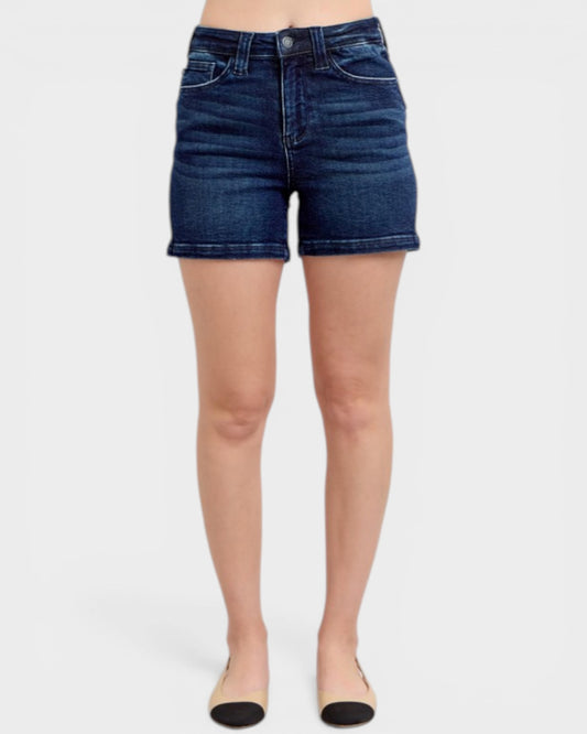 Blue denim shorts worn by a person on a white background