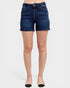 Blue denim shorts worn by a person on a white background