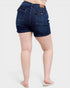 Dark blue denim shorts worn by a person on a white background