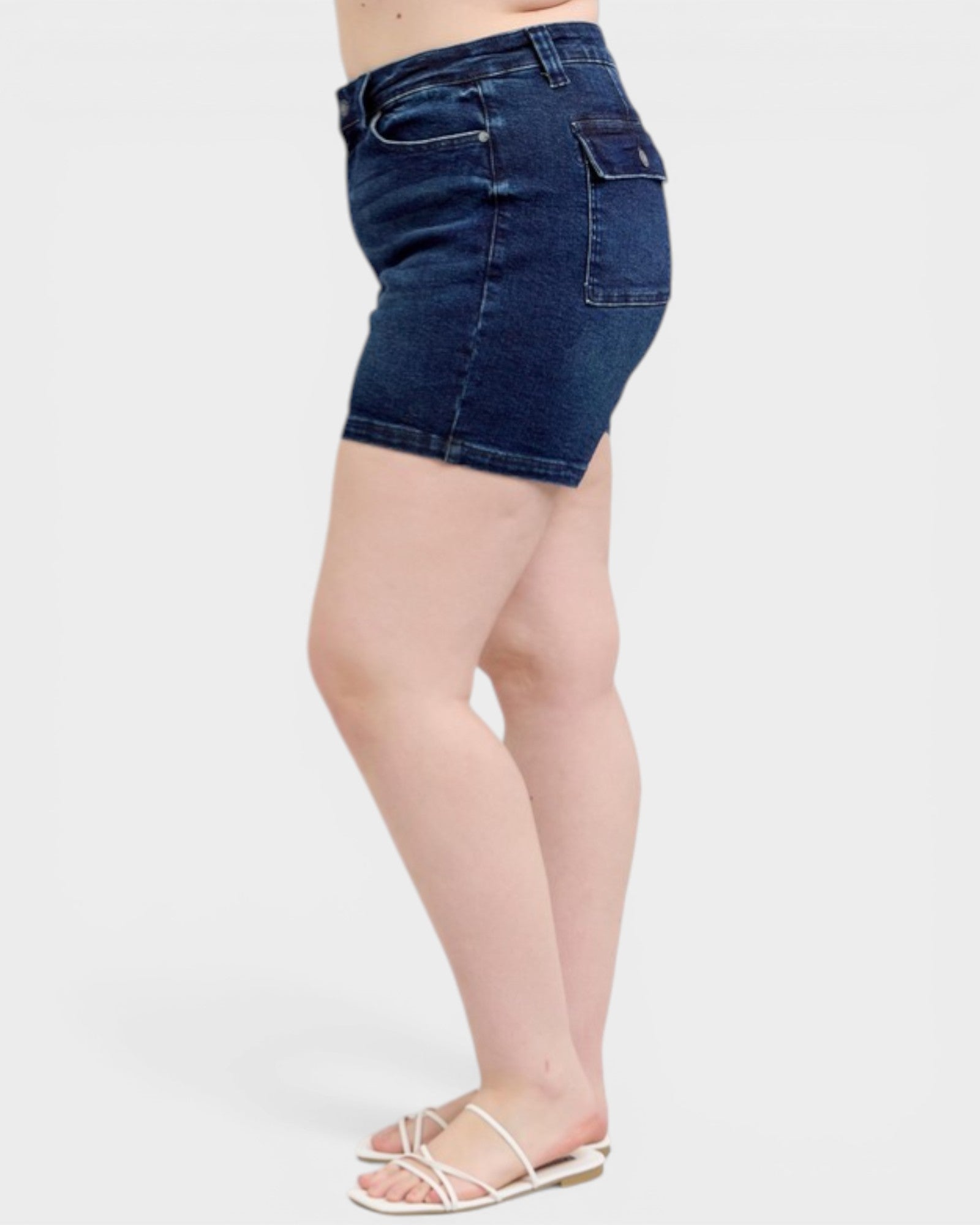 Denim shorts worn by a person on a white background