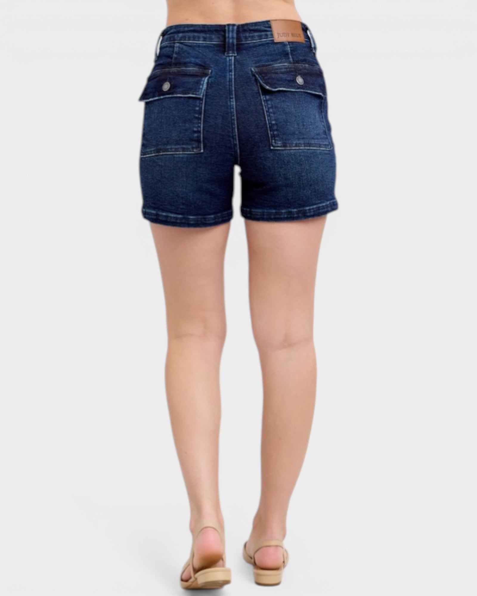 Denim shorts worn by a person on a white background
