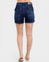 Denim shorts worn by a person on a white background