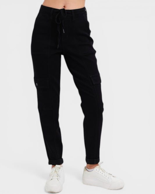 Black cargo jogger pants worn by a person on a white background