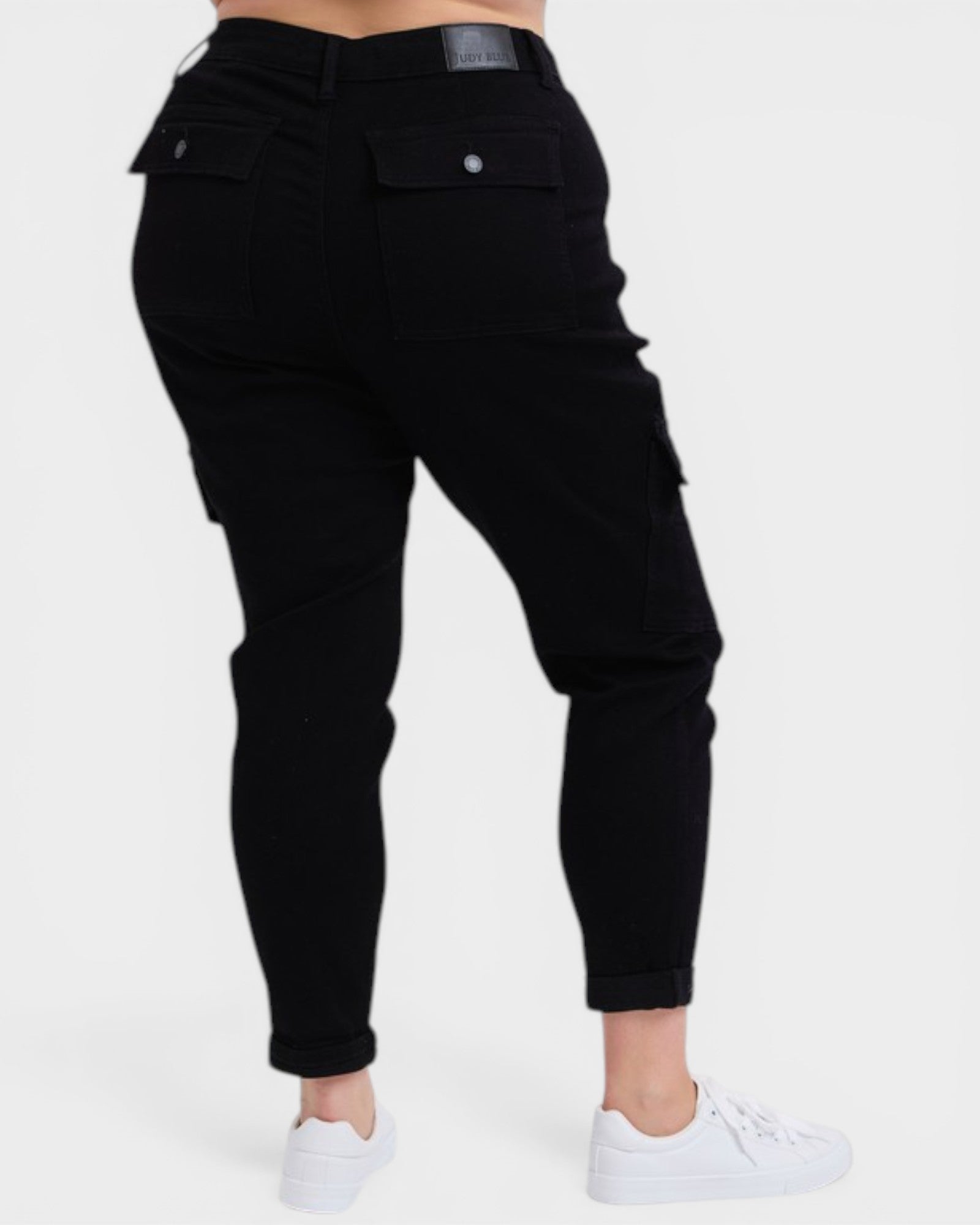 Black cargo pants worn by a person on a white background