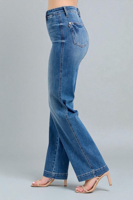 Blue jeans worn by a person on a gray background