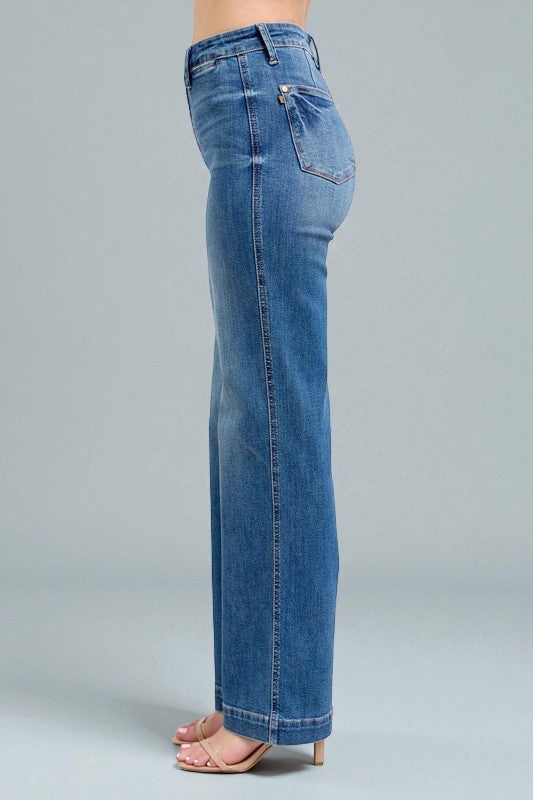 Blue jeans worn by a person on a gray background