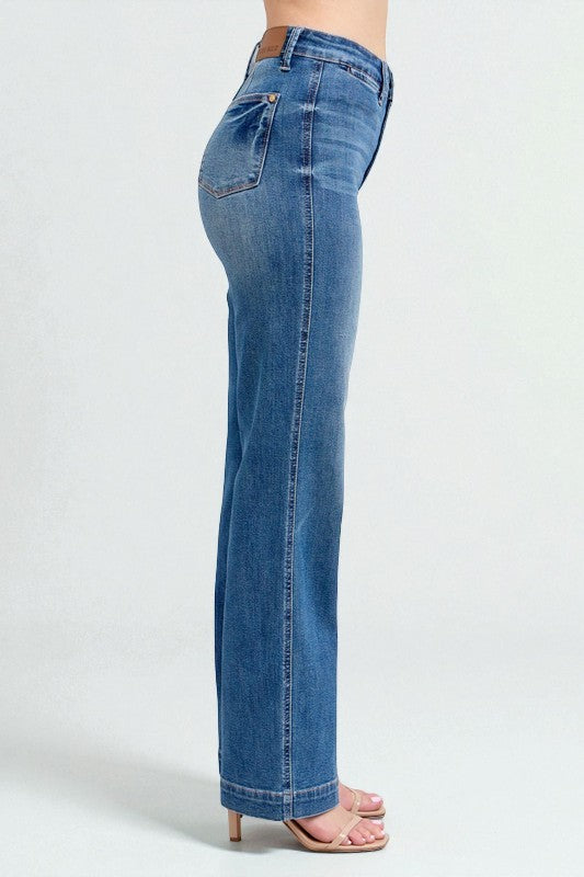 Blue jeans worn by a person on a white background