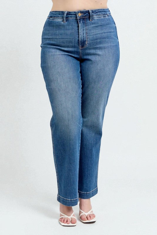 Blue jeans worn by a person on a white background