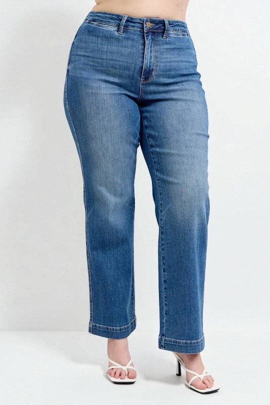 Blue jeans worn by a person on a white background