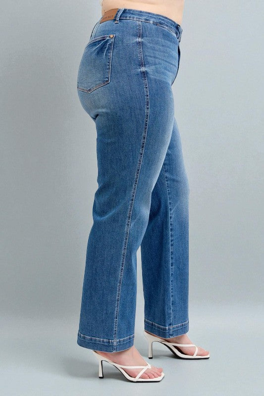 Blue jeans worn by a person on a gray background