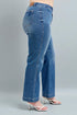 Blue jeans worn by a person on a gray background