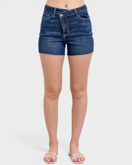 Blue denim shorts worn by a person on a white background