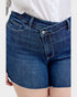 Blue denim shorts worn by a person on a light gray background