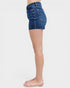 Denim shorts worn by a person on a white background