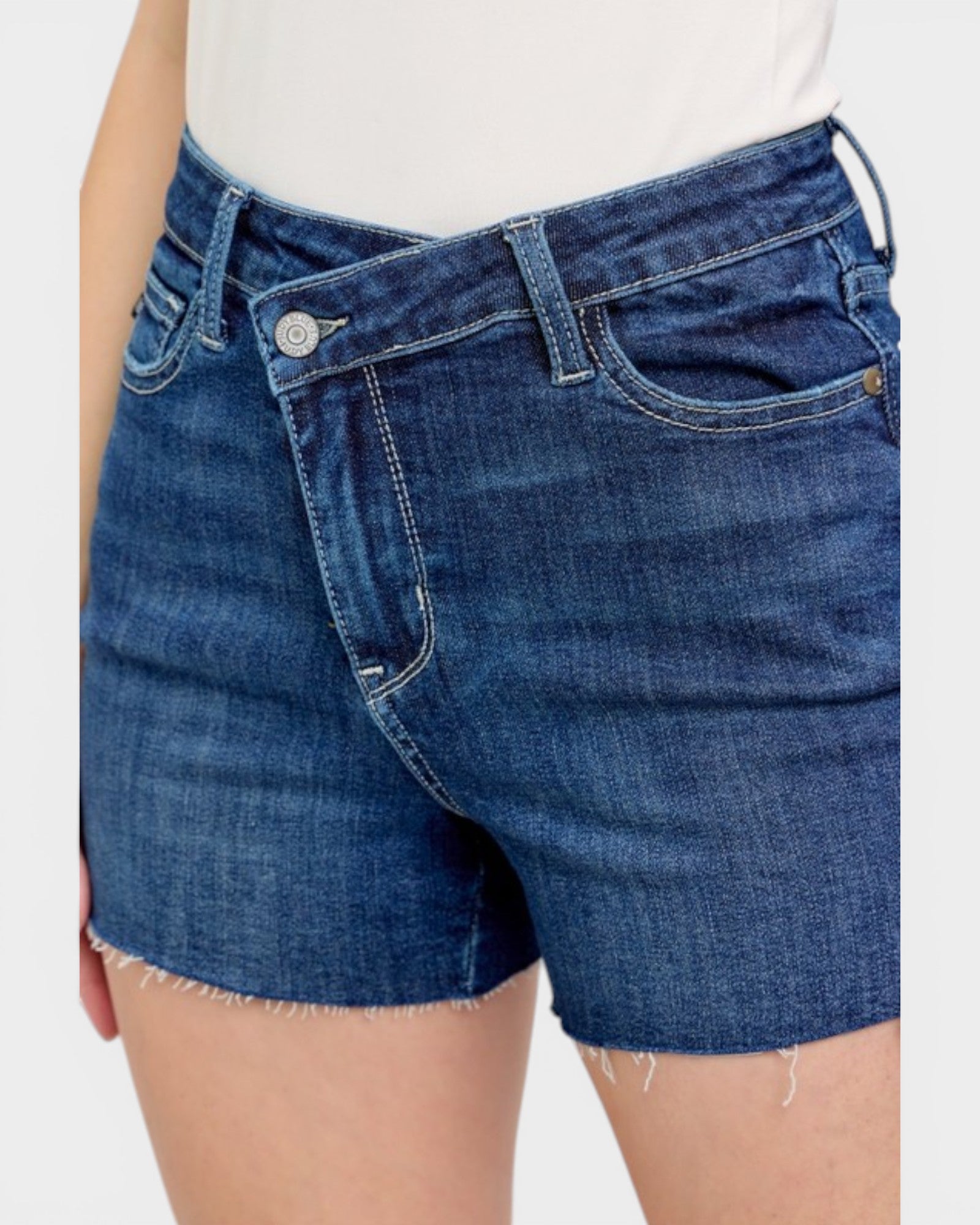 Blue denim shorts worn by a person on a white background