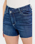 Blue denim shorts worn by a person on a white background