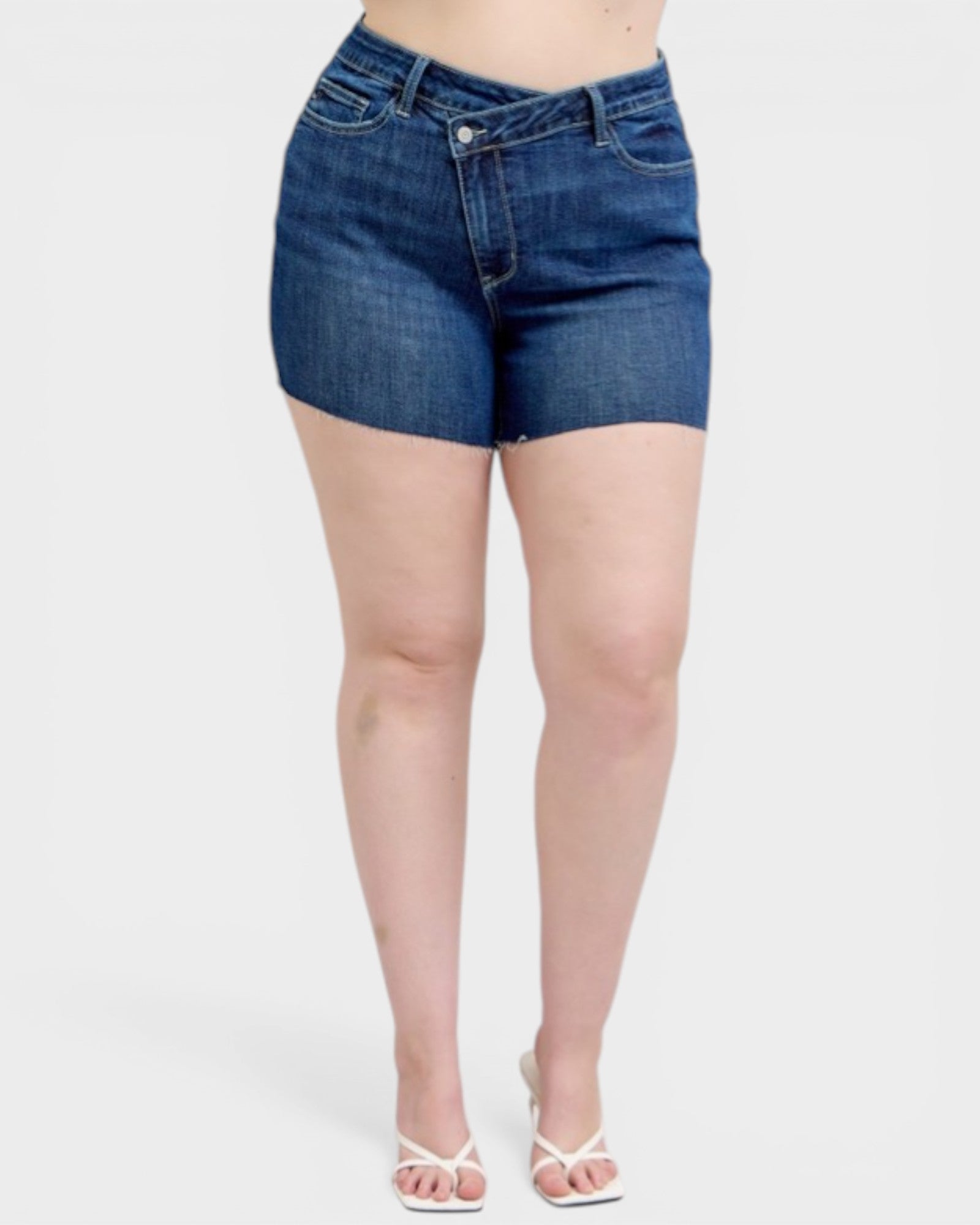 Person wearing blue denim shorts on a white background