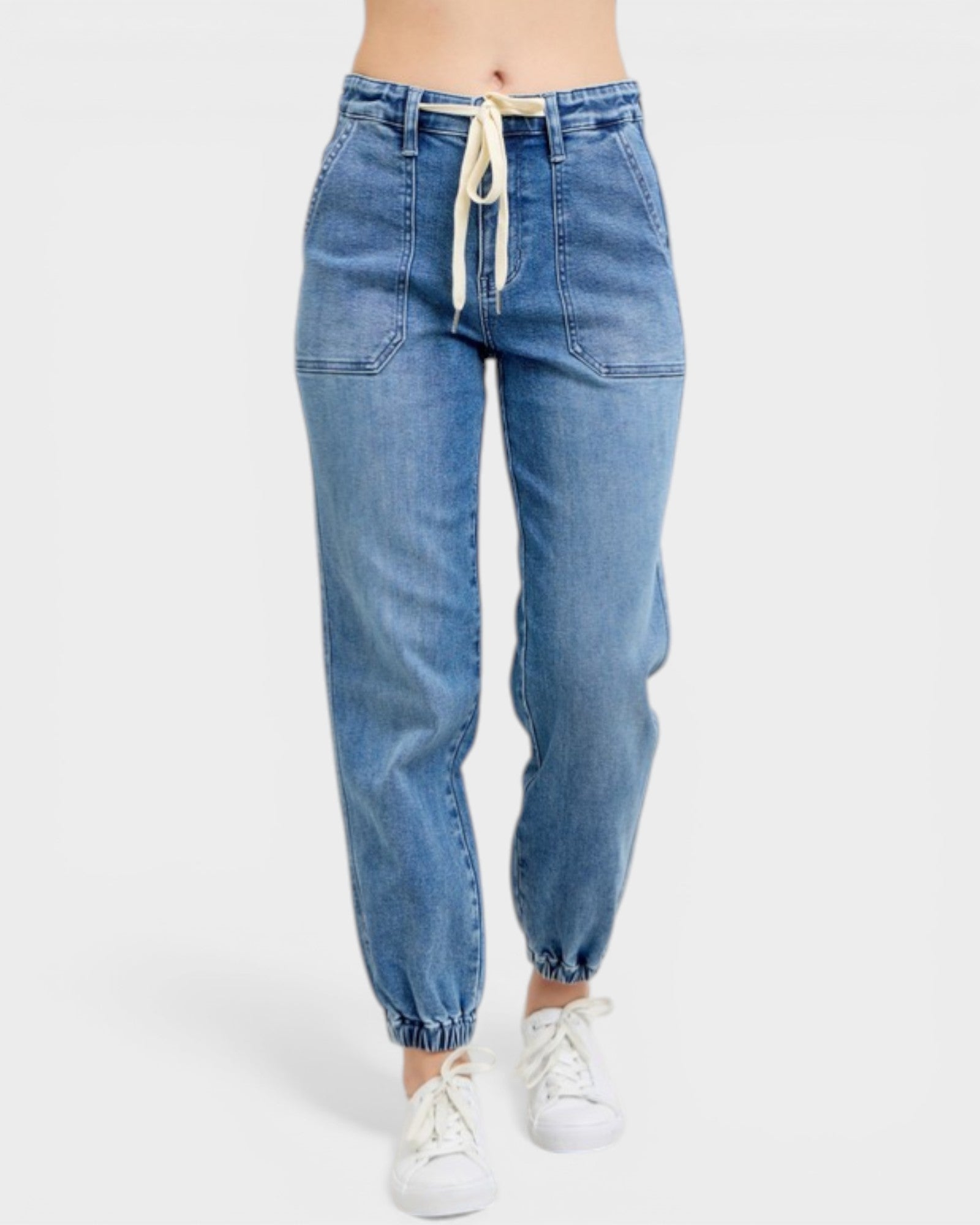 Blue jeans worn by a person on a white background